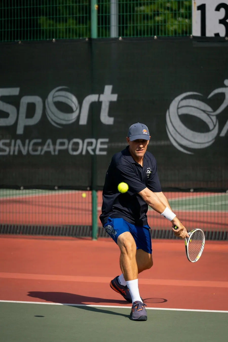 Fred hitting a backhand slice on court